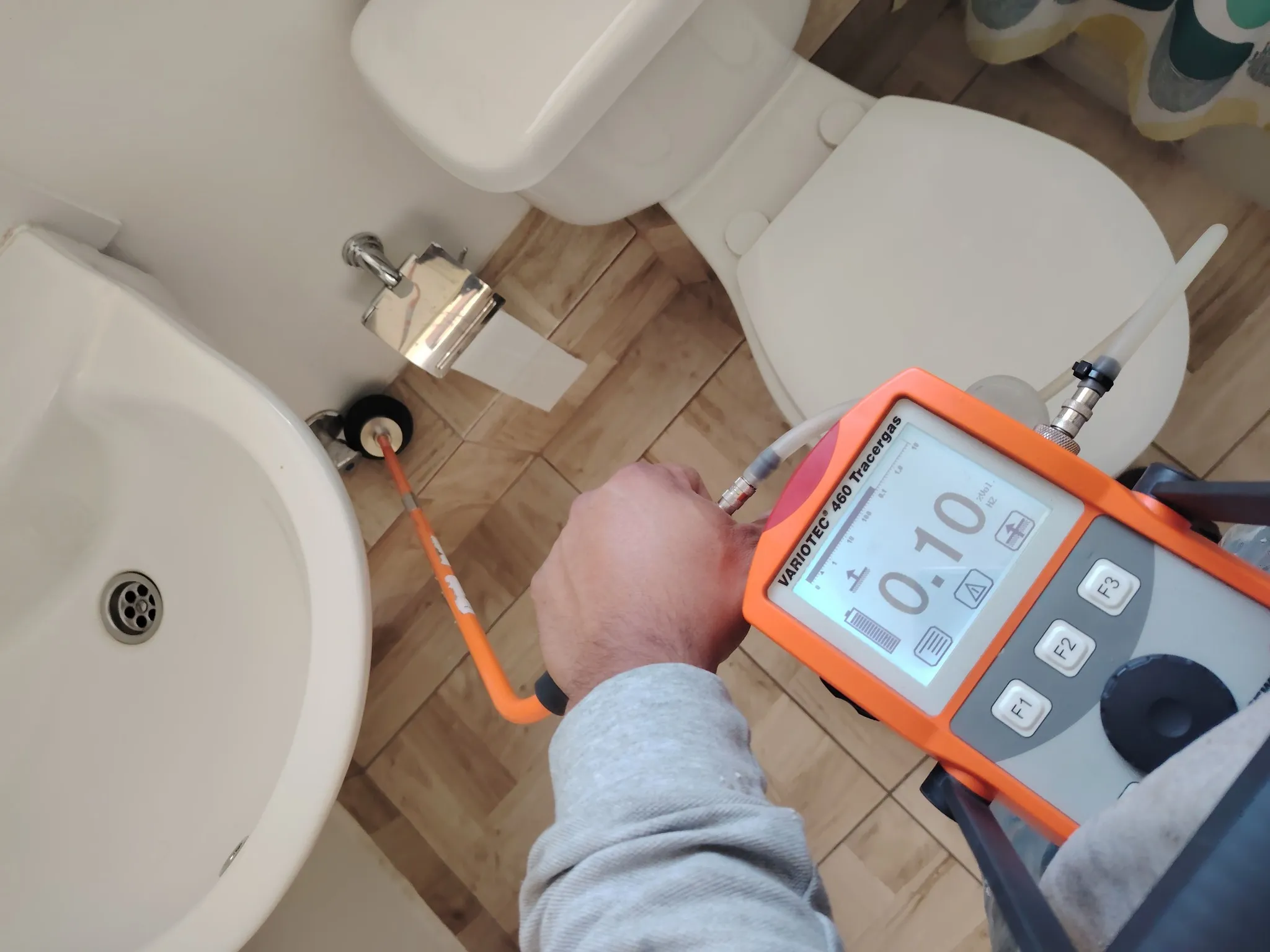 Técnico de MasterFuga detectando una fuga de agua con geófono en el baño de un departamento en Santiago